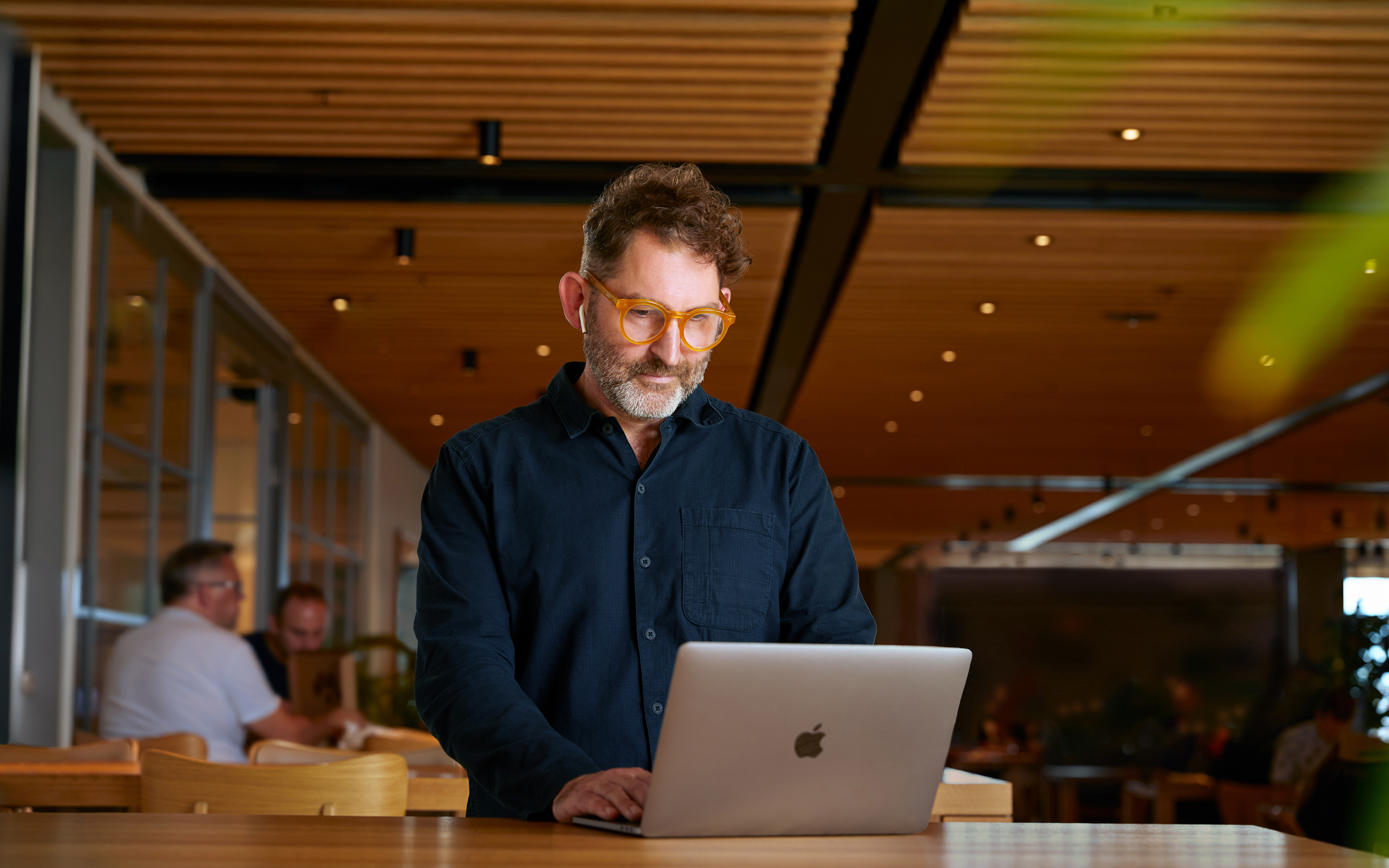 An Apple Corporate Functions team member using a MacBook in Caffè Macs.