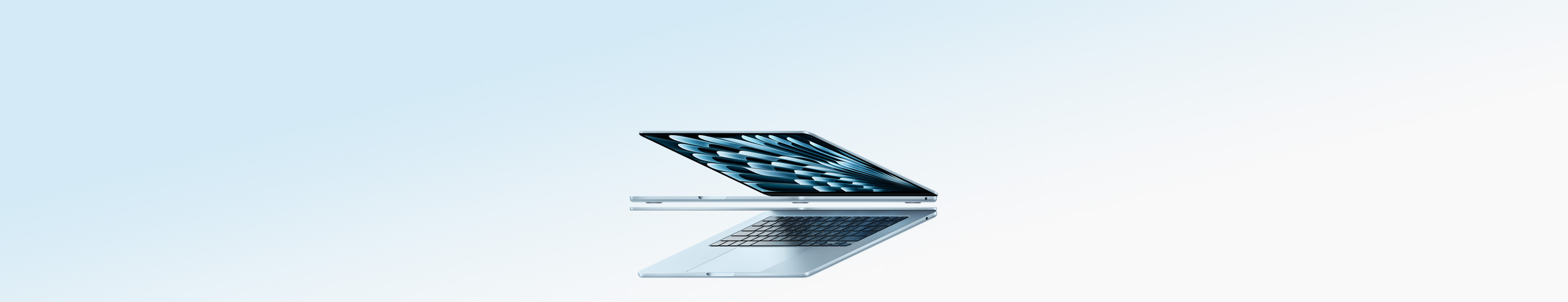 Two open MacBook Air laptops in sky blue colour forming arrow shape, emphasising narrow profile